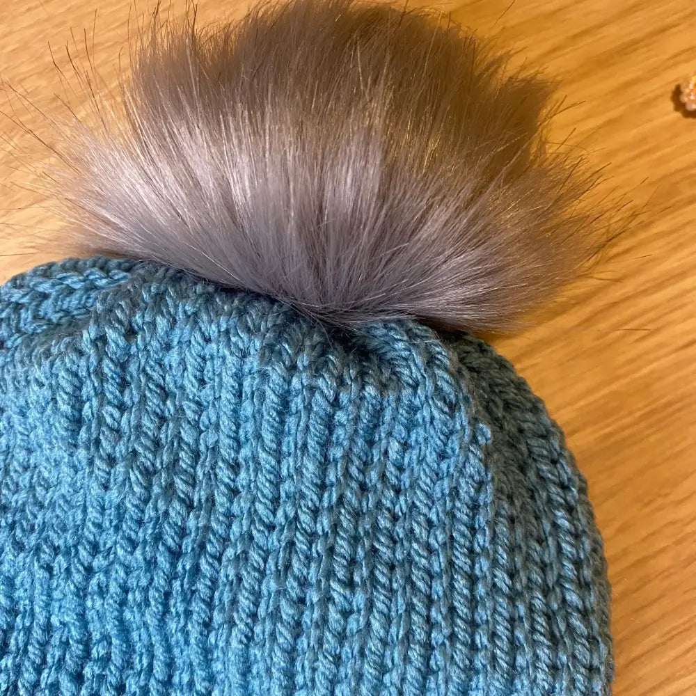 Storm Blue Knitted Hat with Faux Fur Pom and Faux Leather Tag - WINTER HAT KNITTED