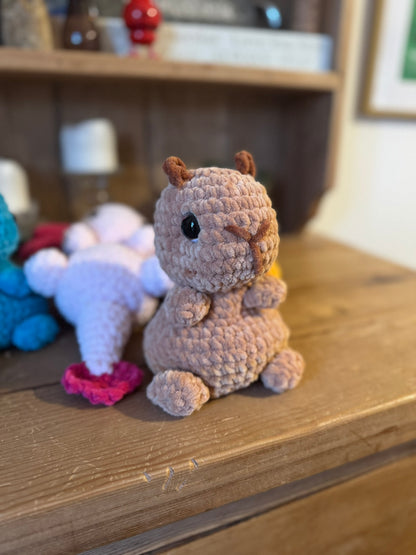Crocheted animal figurine on a wooden surface with a blurred background