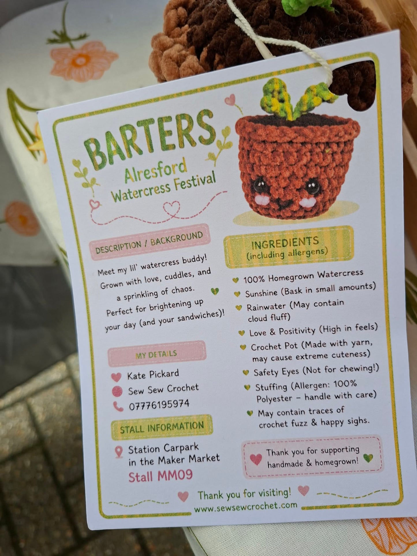 Card with a crocheted watercress plant and event information for BARTERS Alresford Watercress Festival.