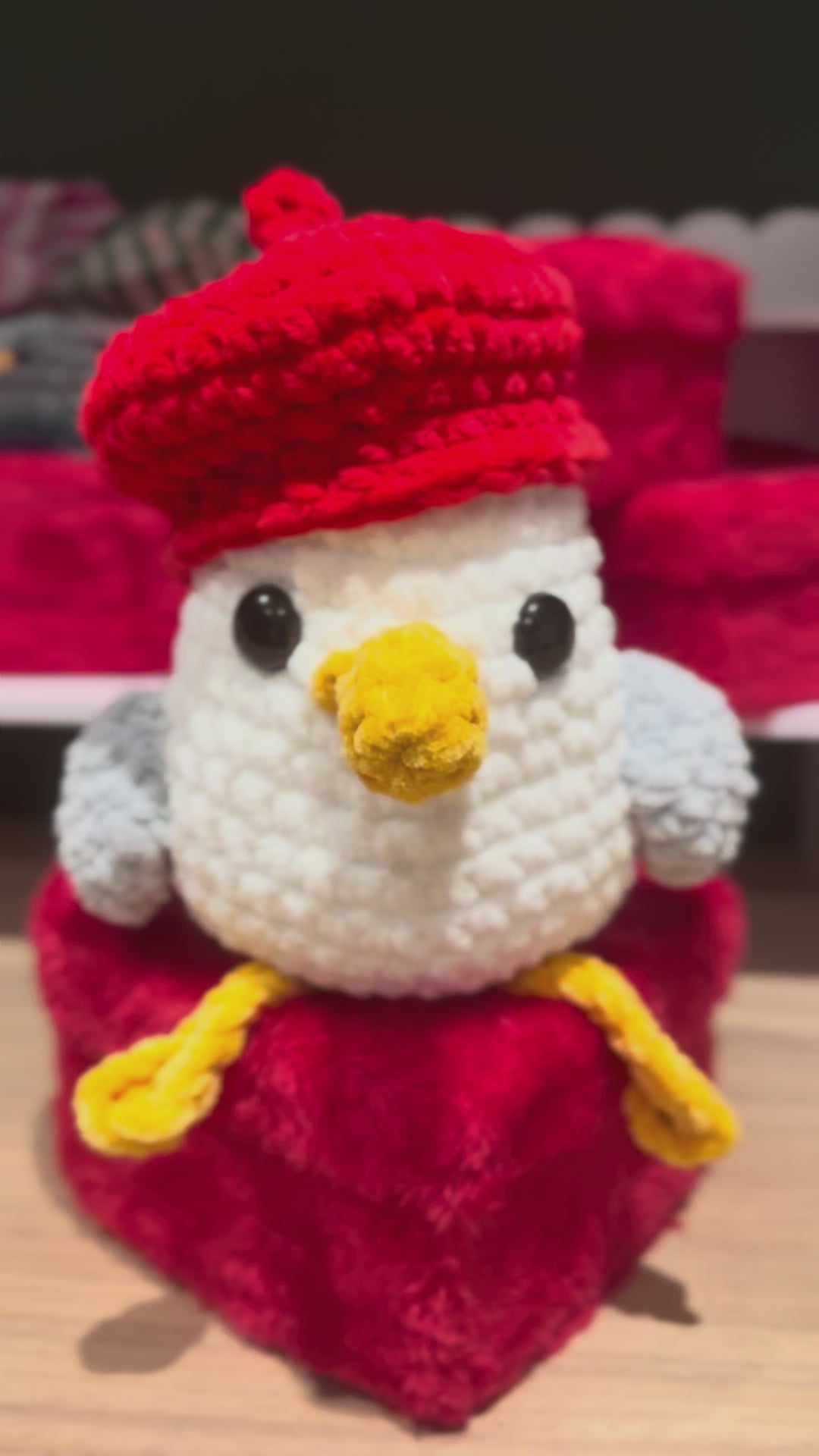 Steven Seagull a crochet gull sitting on a plush heart